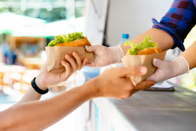 man buying two hot dog kiosk outdoors street food close up view 8353 6322